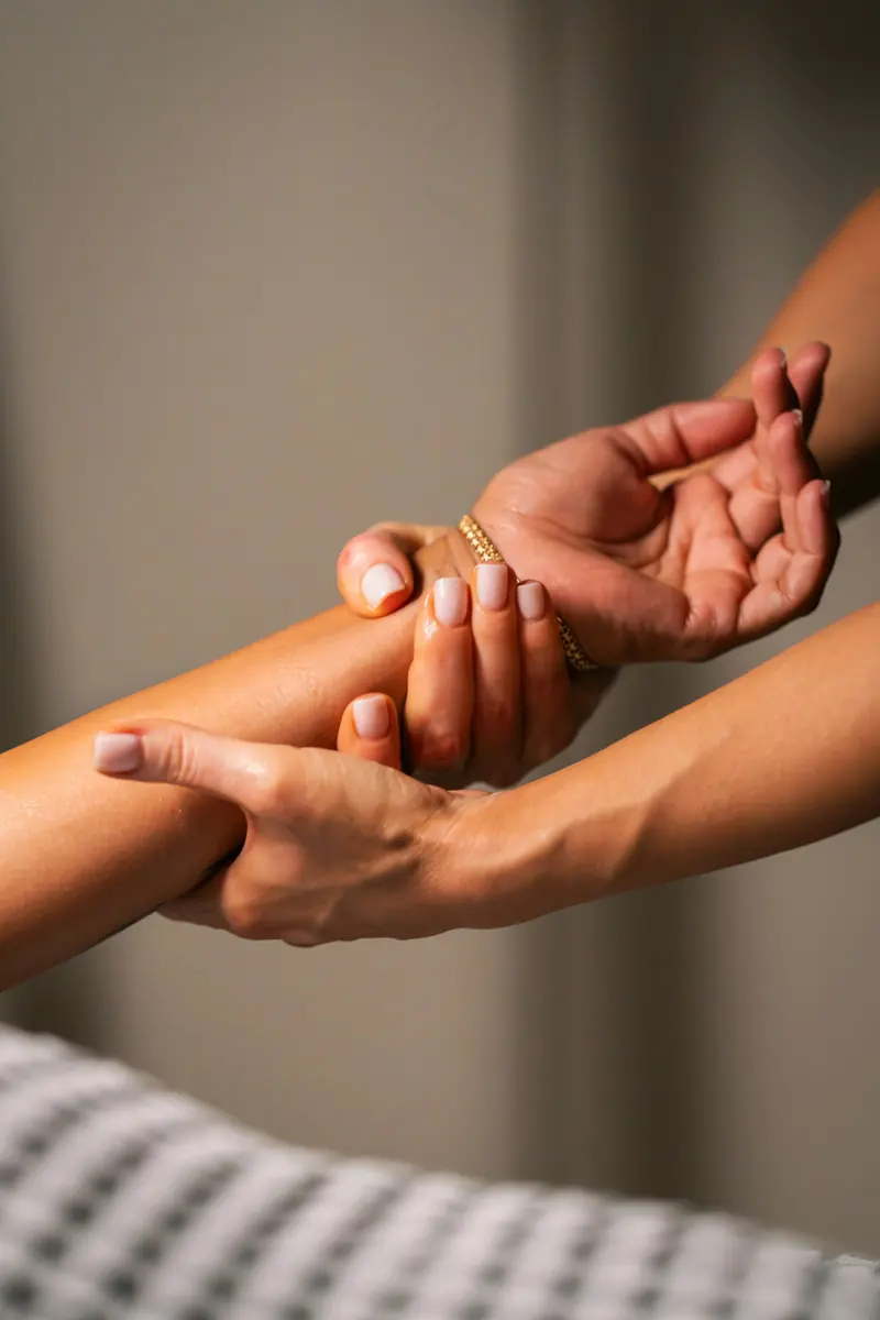 Hands massaging a forearm