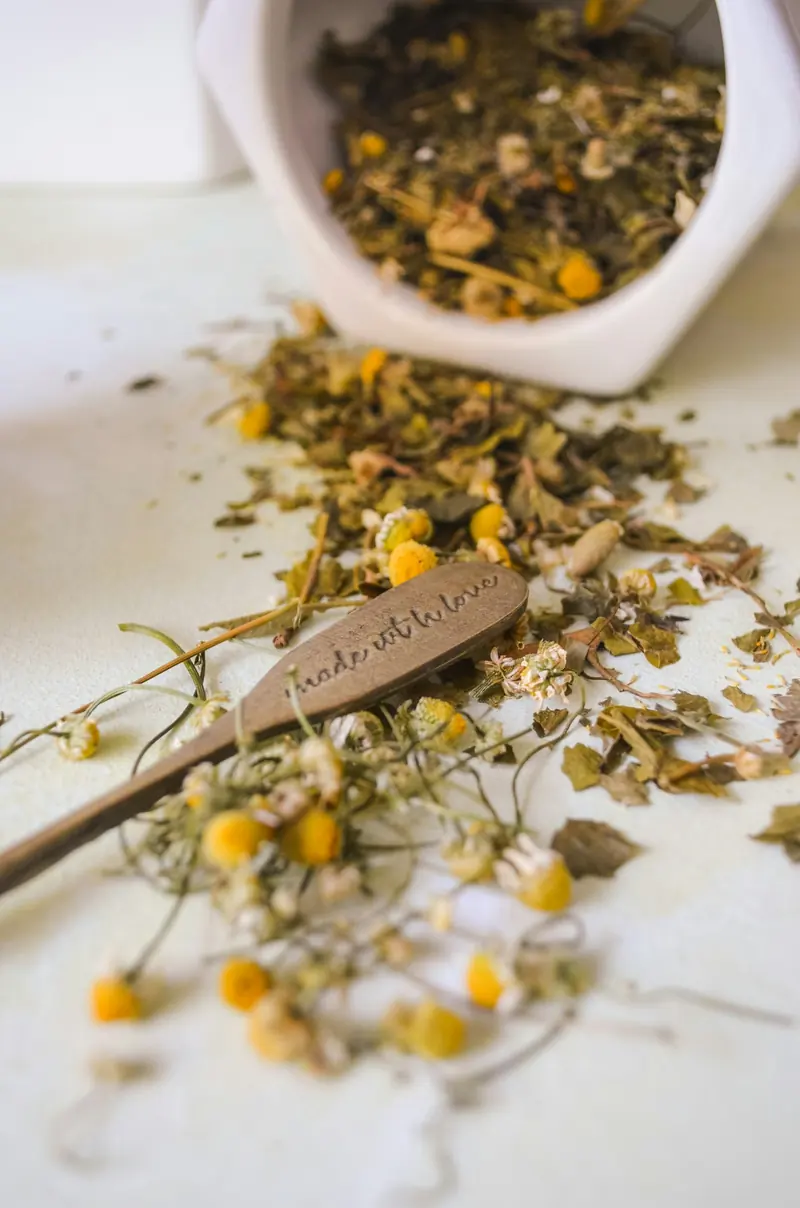 Loose chamomile tea spilling from a bowl