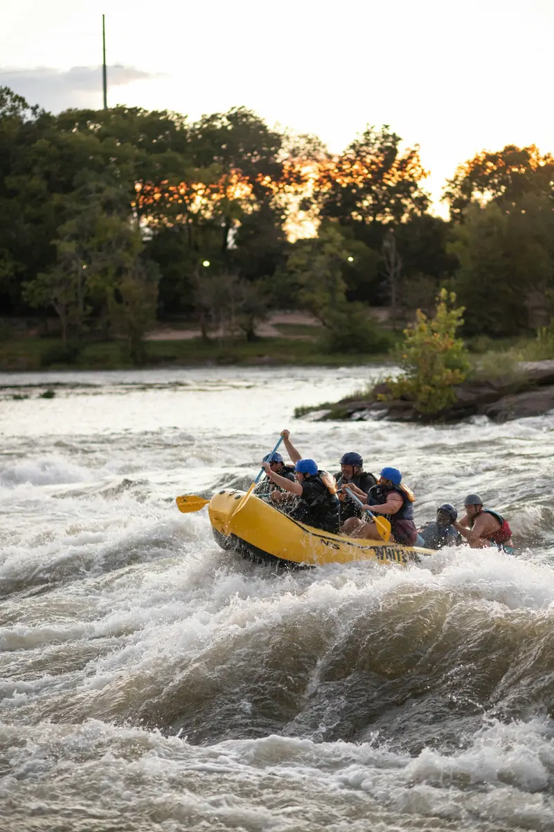 A raft full of people going through whitewater