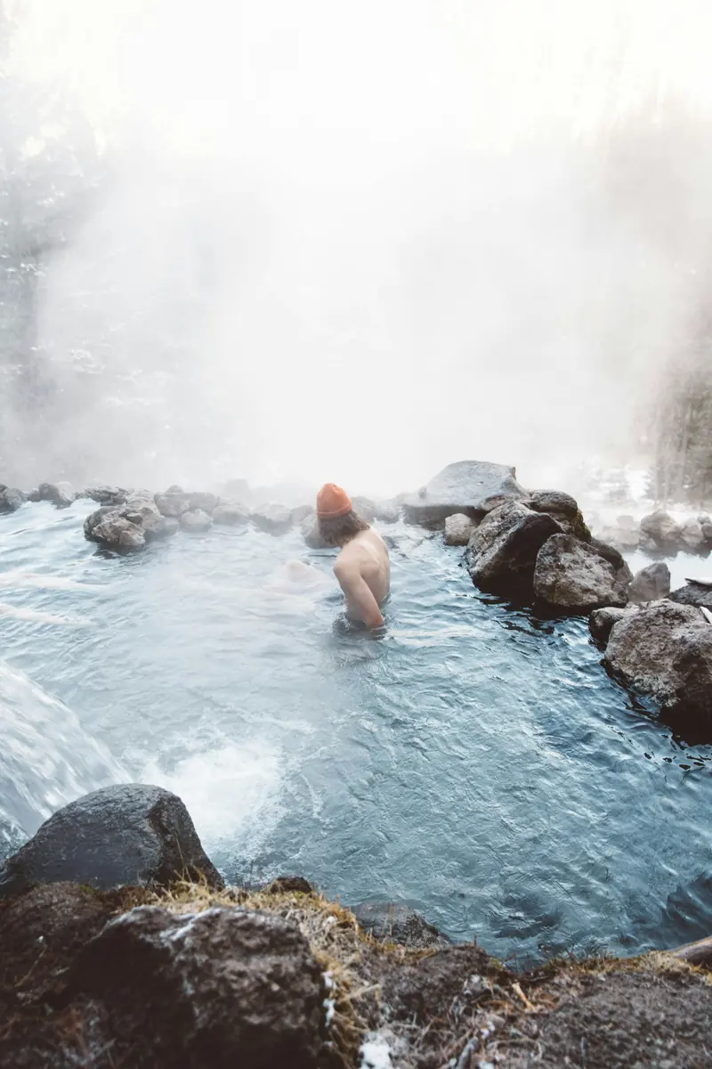 A man sitting in a steaming hot spring