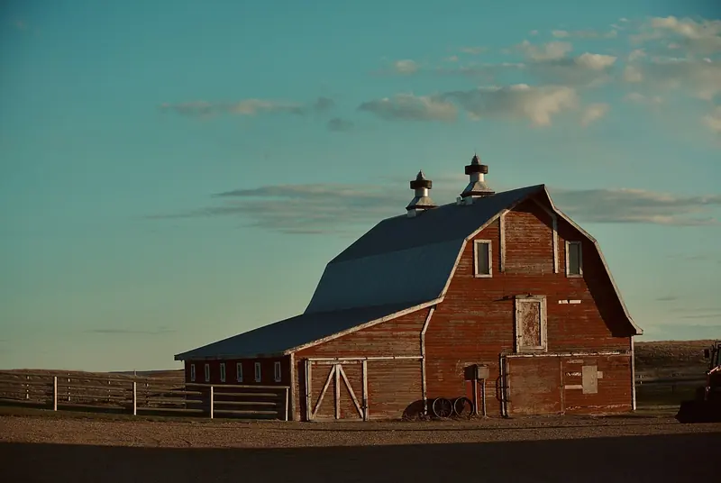 A red barn under a blue sky