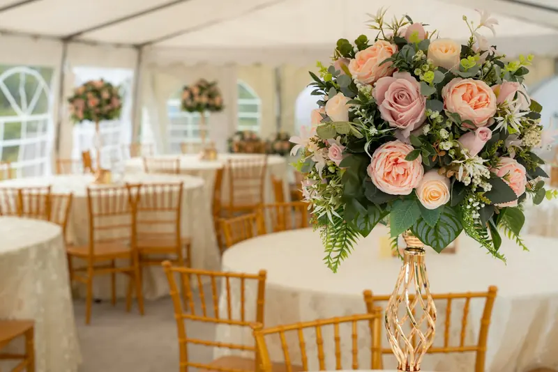 A flower centerpiece in a white tent