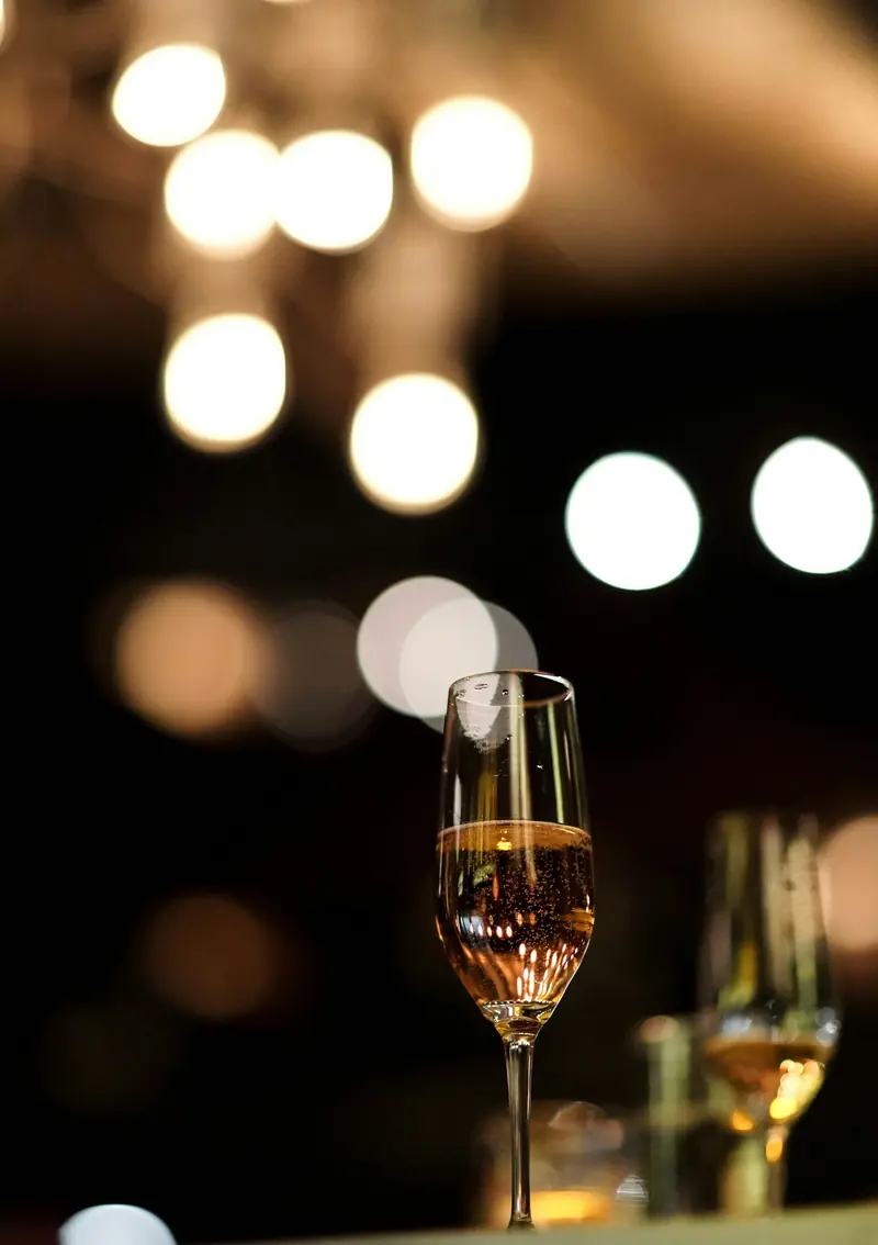 A glass of champagne in low light