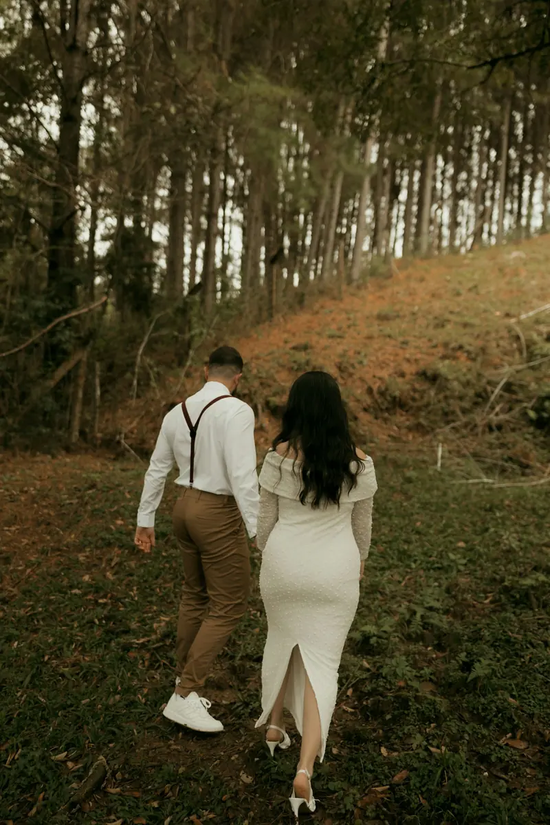 A couple walking uphill through the pines