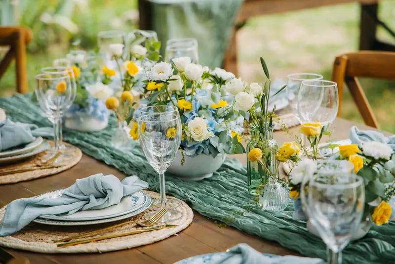 A table set with small flower arrangements