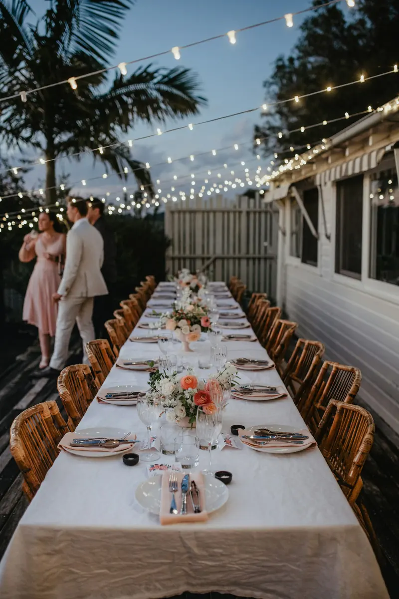 A long reception table under string lights