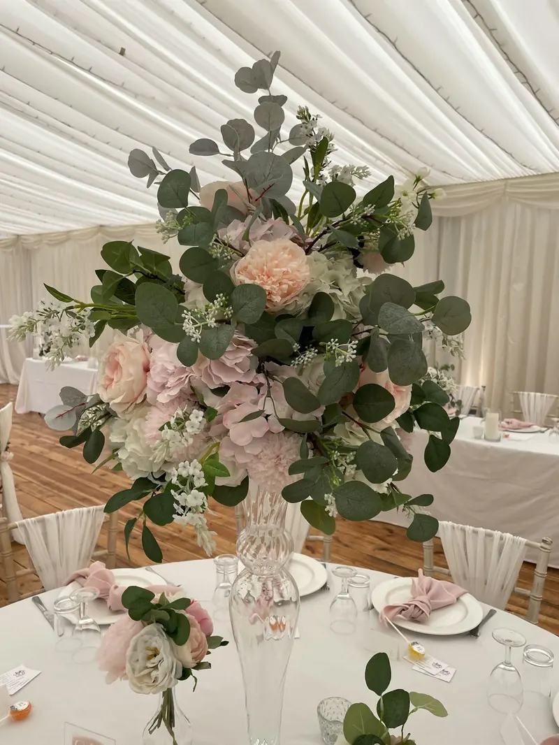 A tall flower arrangement on a reception table