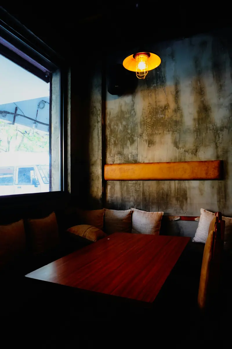 A warm booth with a lamp on the table