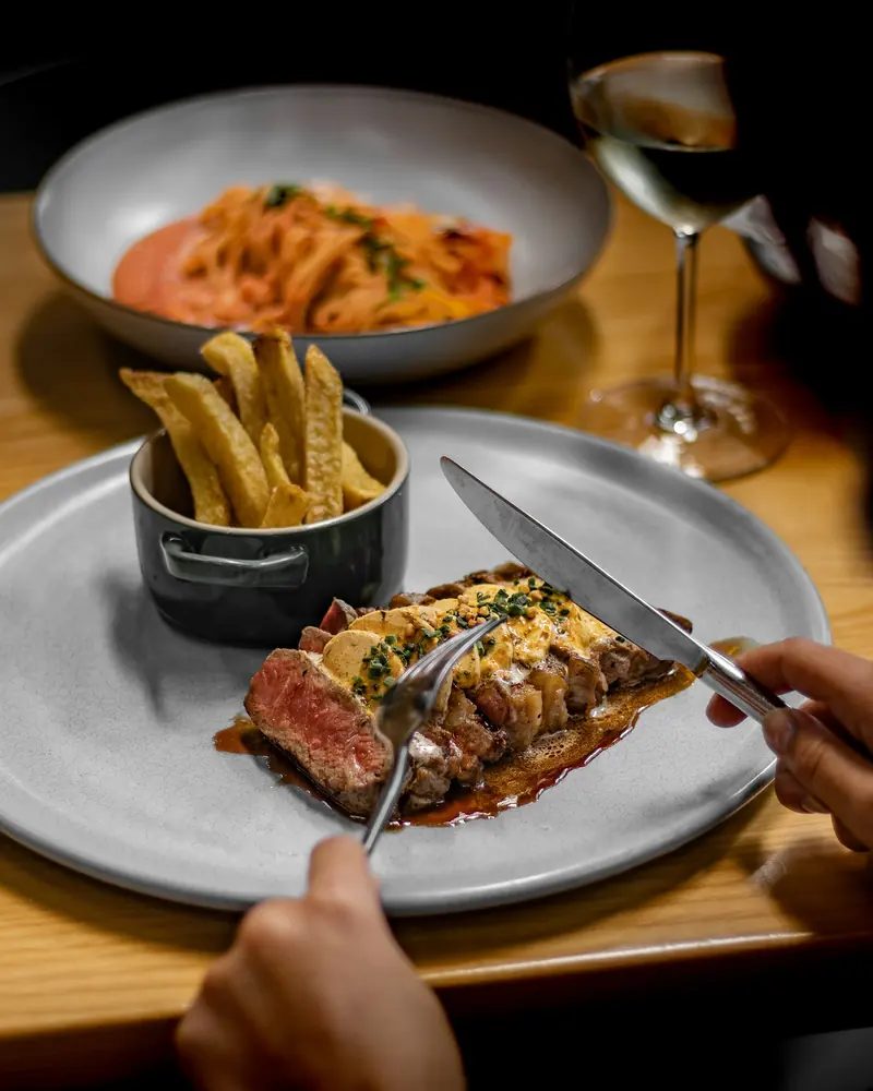 Cutting into a steak dinner