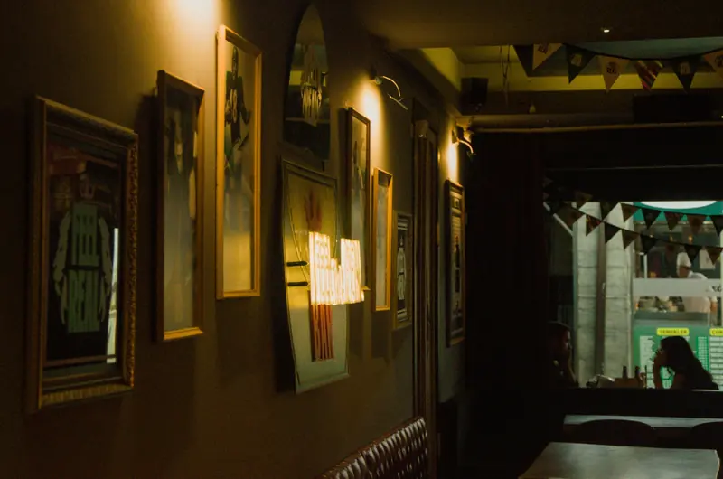 Framed pictures on a dark wall in warm light