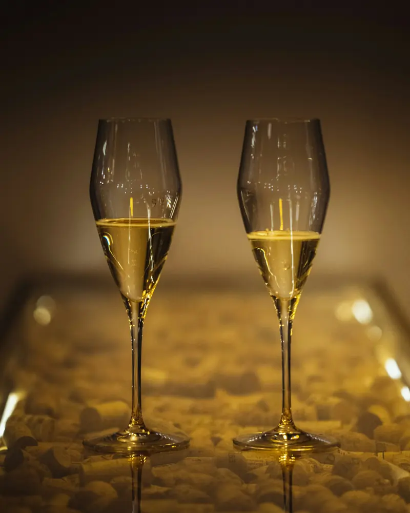 Two glasses of champagne in low light