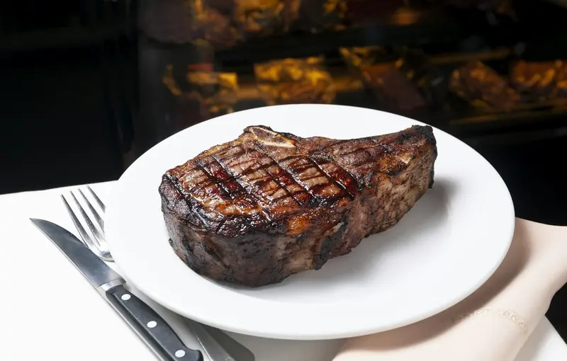 A grilled steak on a white plate