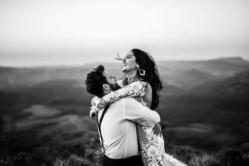 A couple hugging on a hillside
