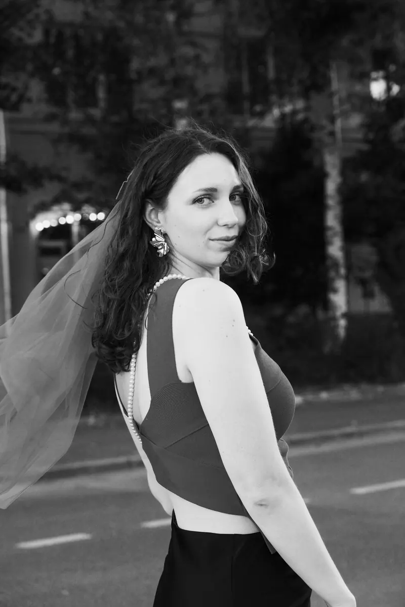 A woman in a veil looking back over her shoulder