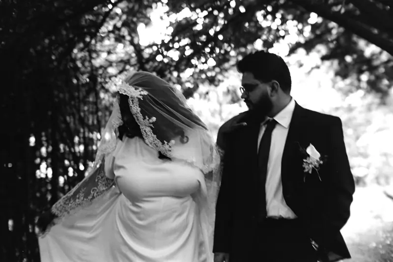 A bride and groom walking together outdoors