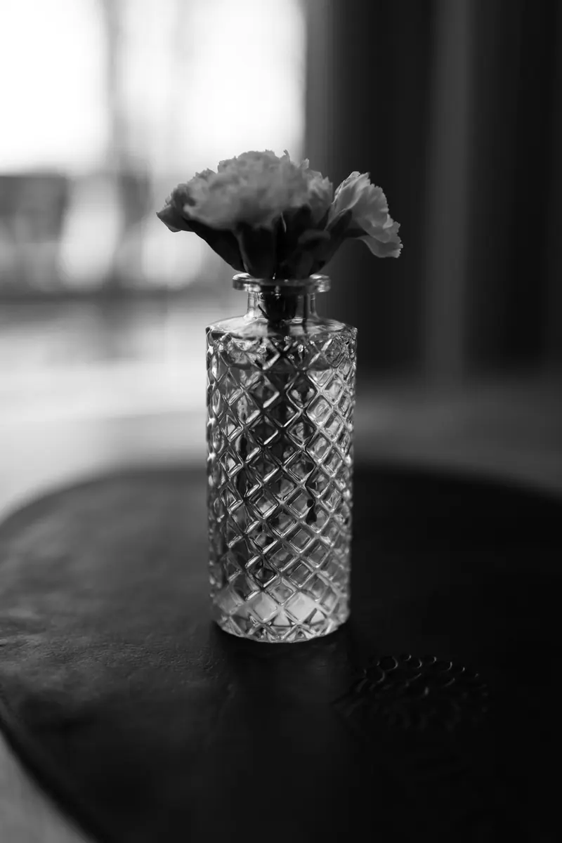 A single flower in a cut crystal vase