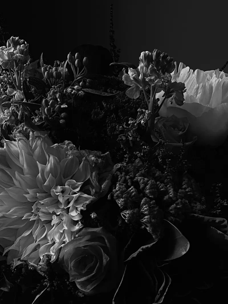 A dark bouquet of roses and lilies