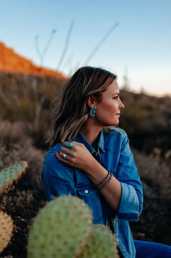 Kaylee in a denim shirt and turquoise earrings