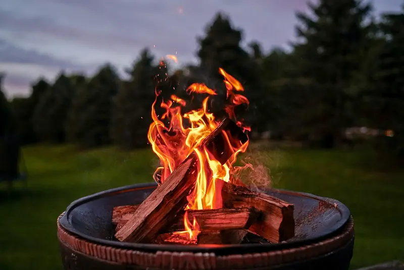 A fire burning in a fire pit at dusk