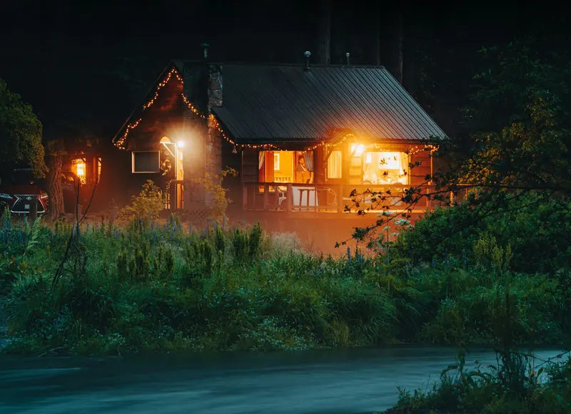 A cabin with warm windows at night
