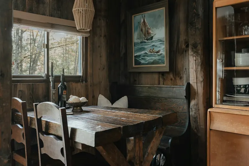 A wooden table and chairs in a cabin kitchen