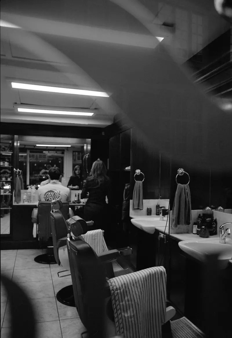 An old barbershop with customers in the chairs