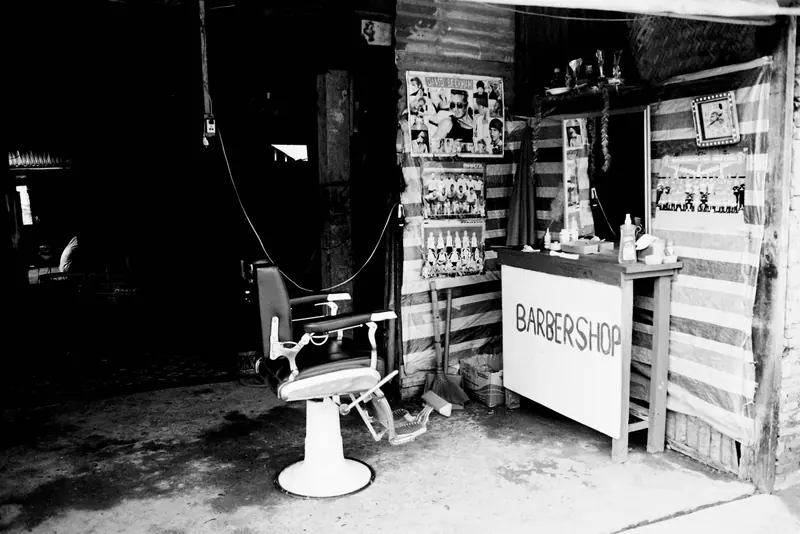 An empty barber chair in a small shop