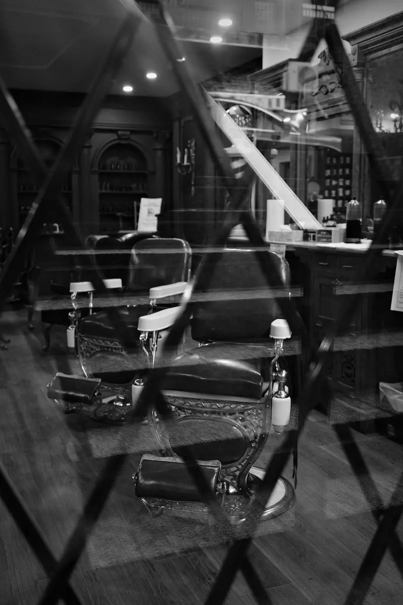 Old barber chairs reflected in a window