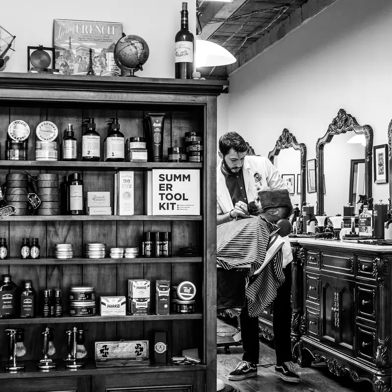 A barber shaving a man's chin
