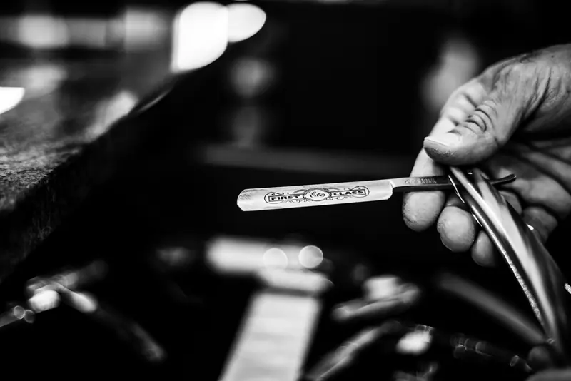 A barber holding a pair of scissors