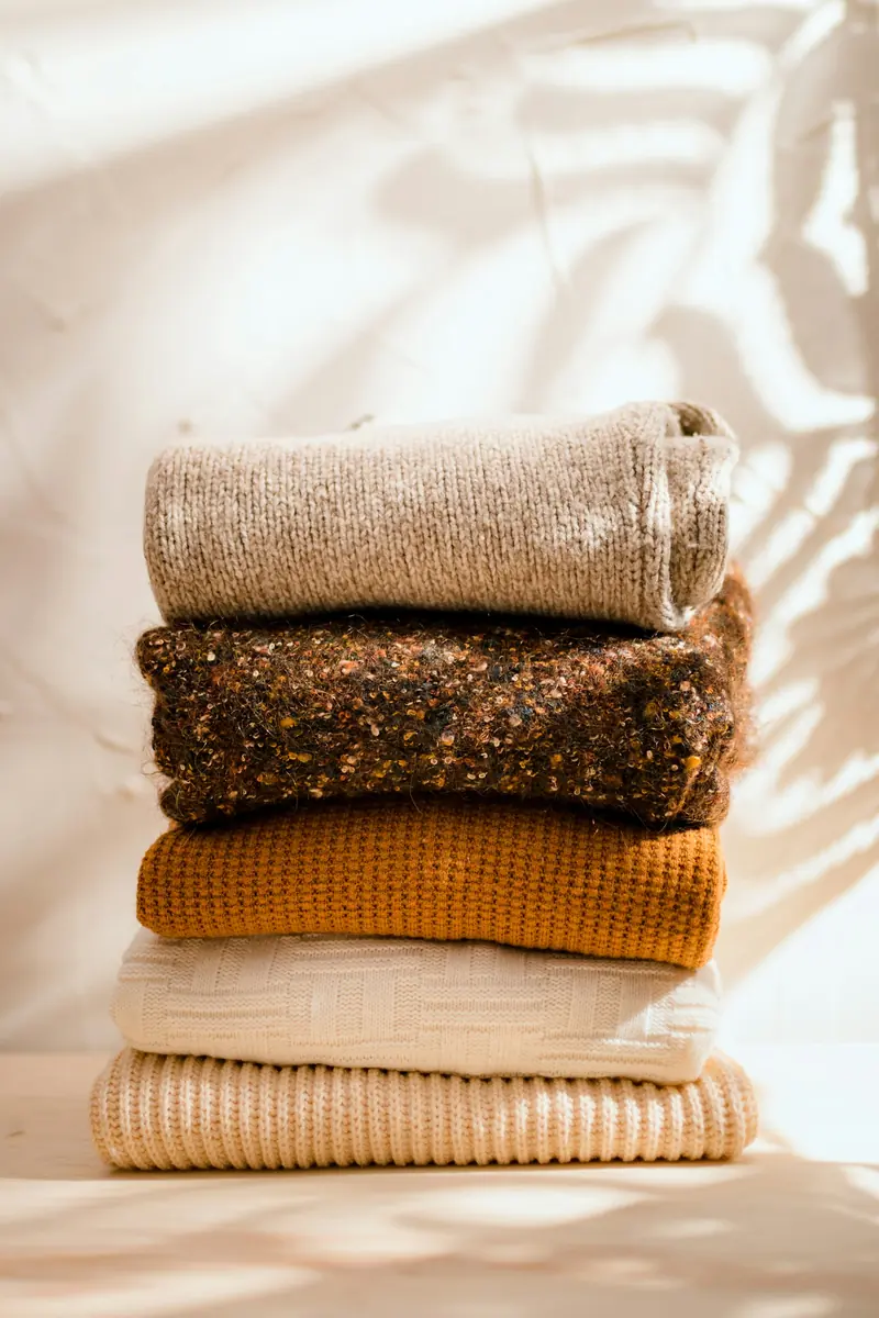 A stack of cream sweaters