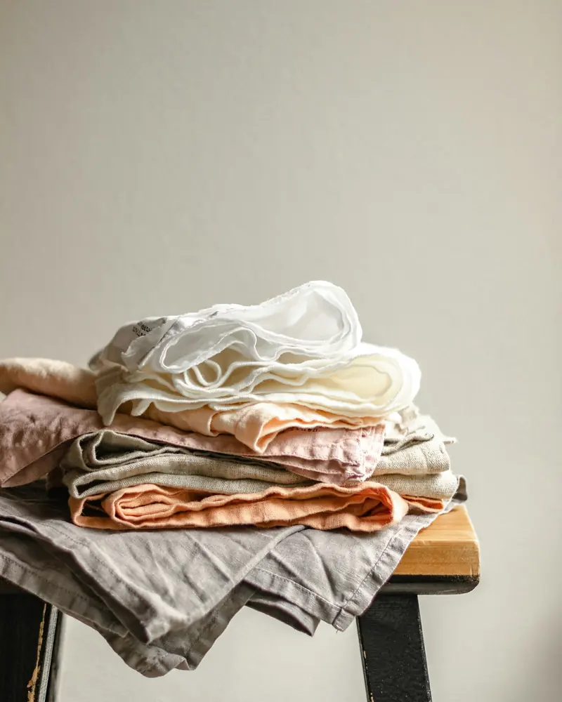 Folded linen on a stool