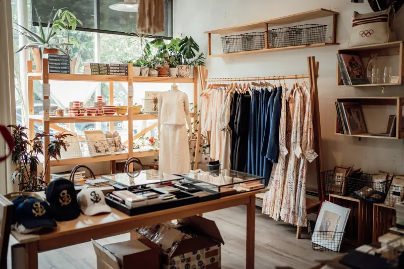 A small shop with clothes, hats and shelves