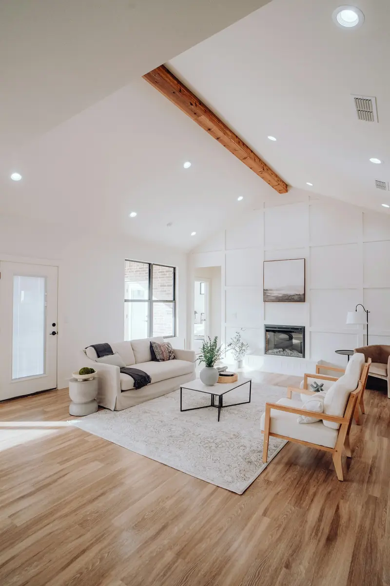 A living room with a fireplace and a reading chair