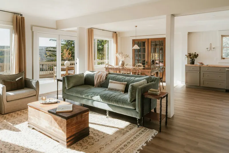 A green sofa and a wood chest