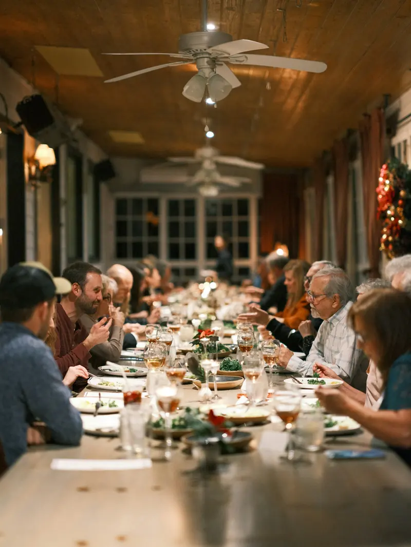 Friends sitting down to supper at a long table