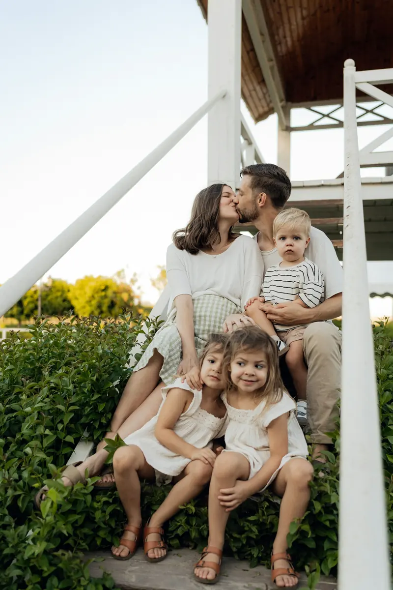 A family sitting together on their porch steps